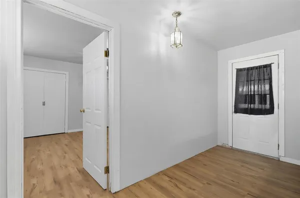 a view of hallway with wooden floor