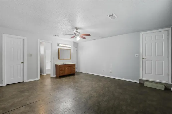 an empty room with a empty space and windows