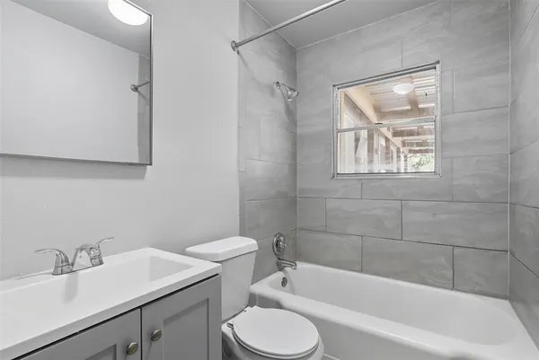 a bathroom with a sink toilet and bathtub