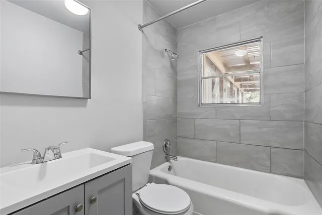 a bathroom with a sink toilet and bathtub