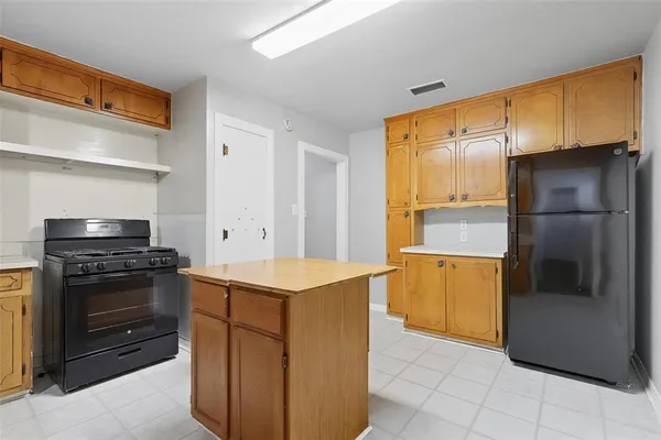 a kitchen with stainless steel appliances granite countertop a refrigerator and a stove
