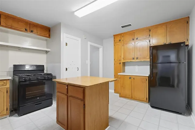 a kitchen with stainless steel appliances granite countertop a refrigerator and a stove