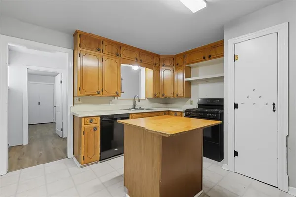 a spacious bathroom with a granite countertop sink and a mirror