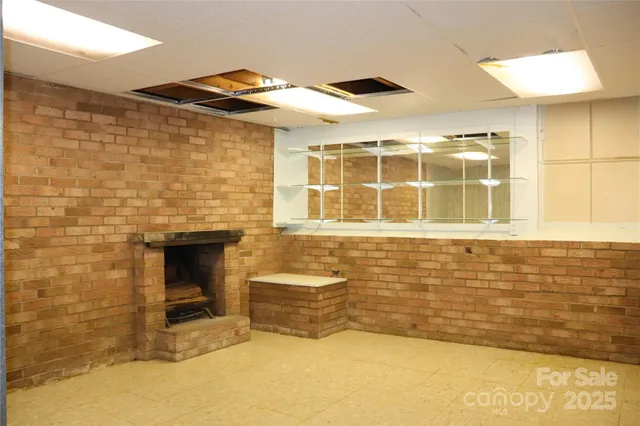 a view of a room with wooden walls and a window