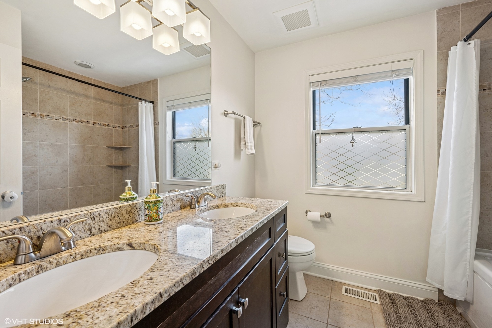 512 Braemar Lane Barrington, IL 60010 - Photo 16 of 24 a bathroom with a granite countertop sink a toilet a mirror a vanity and shower