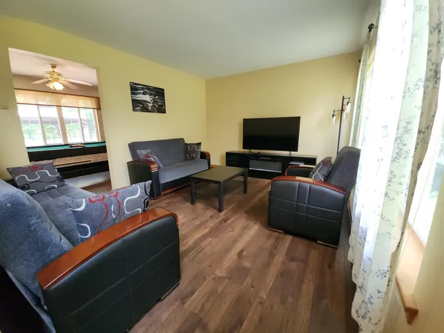 a bathroom with a granite countertop toilet and sink