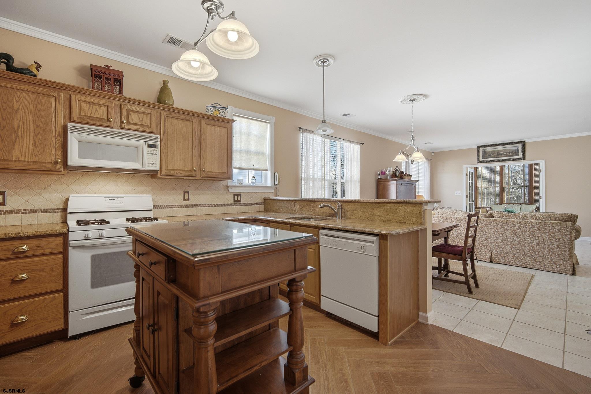 102 Warwick Road Galloway Township, NJ 08205 - Photo 9 of 45 a kitchen with a stove cabinets and window