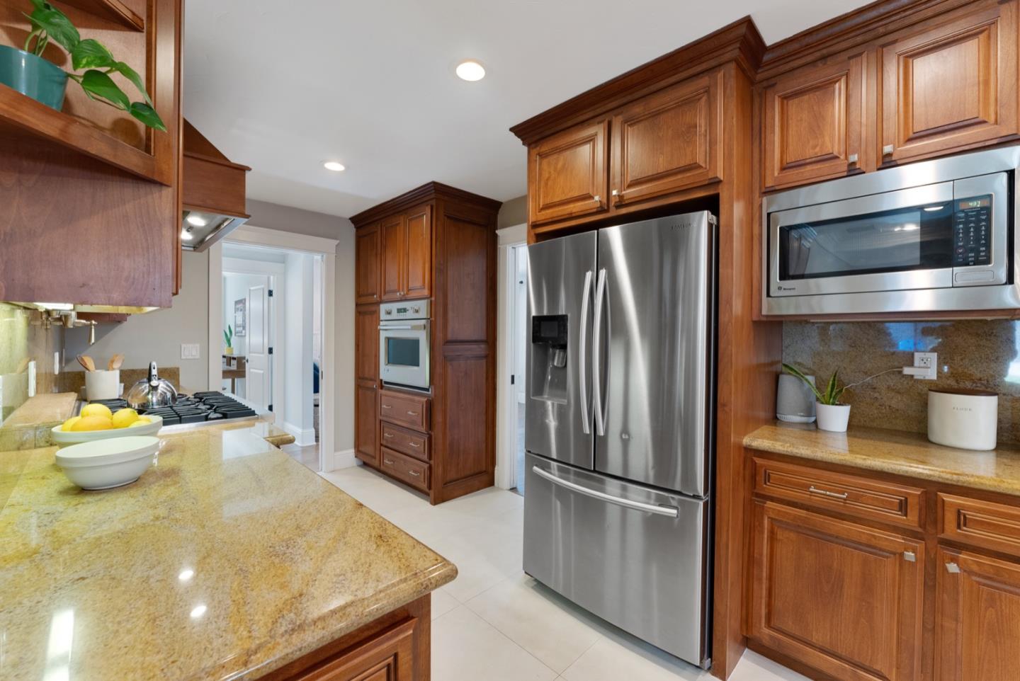 1240 Fewtrell Drive Campbell, CA 95008 - Photo 21 of 50 a kitchen with stainless steel appliances granite countertop a refrigerator a stove and a sink with wooden floor