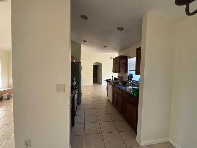 a kitchen with stainless steel appliances granite countertop a refrigerator and a stove top oven