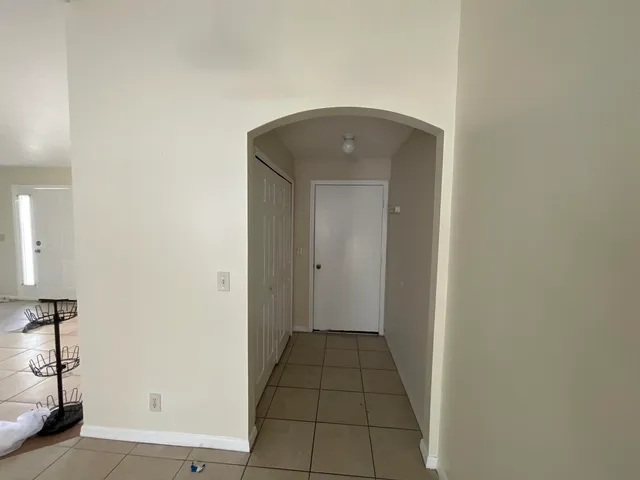 a view of a hallway and closet with a couch