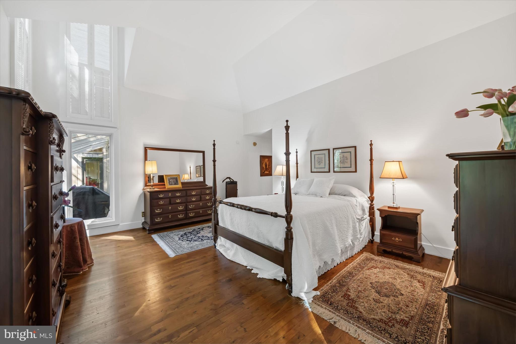 6 Carriage Road Greenville, DE 19807 - Photo 11 of 59 a bedroom with a bed and a flat tv screen on dresser