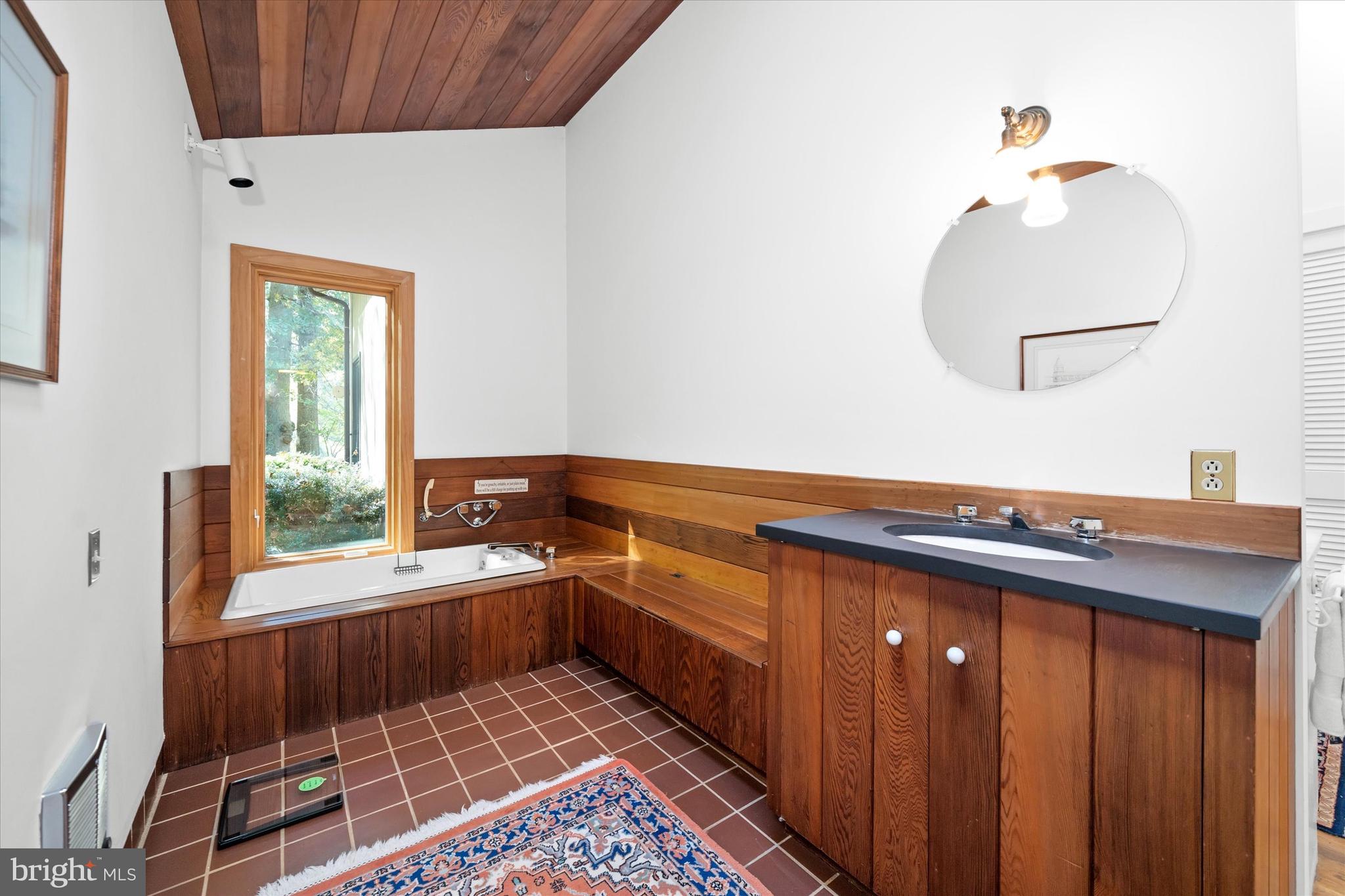 6 Carriage Road Greenville, DE 19807 - Photo 18 of 59 a bathroom with a sink a mirror and a window