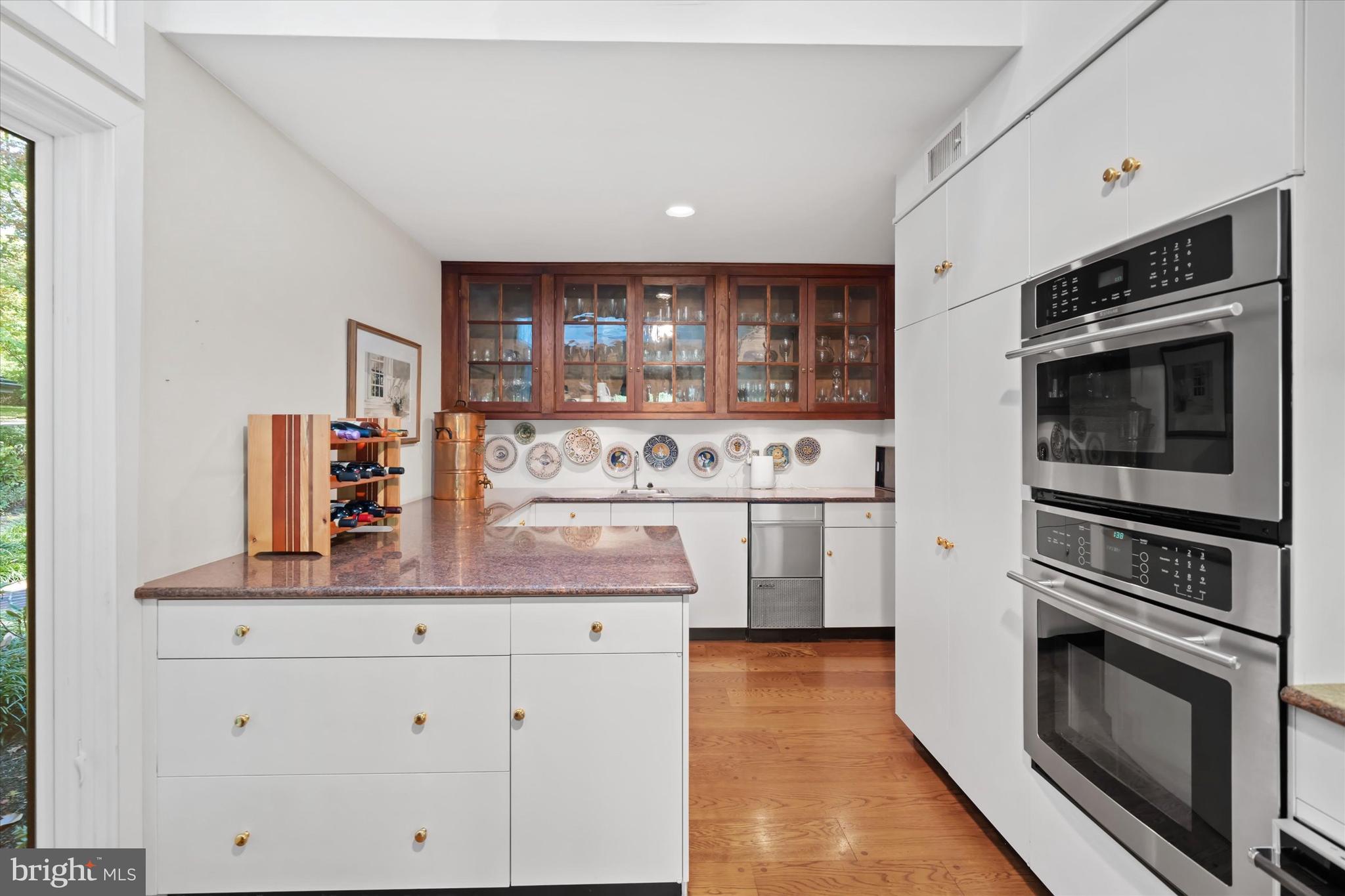 6 Carriage Road Greenville, DE 19807 - Photo 25 of 59 a kitchen with stainless steel appliances a stove microwave and cabinets