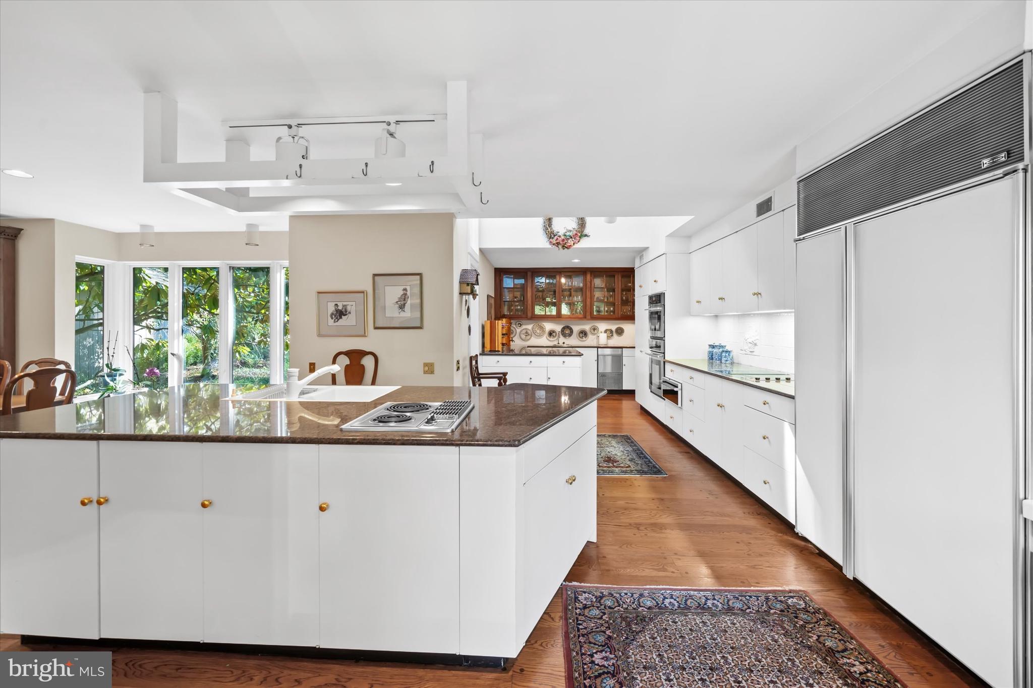 6 Carriage Road Greenville, DE 19807 - Photo 26 of 59 a large kitchen with stainless steel appliances granite countertop a lot of counter space and wooden floor