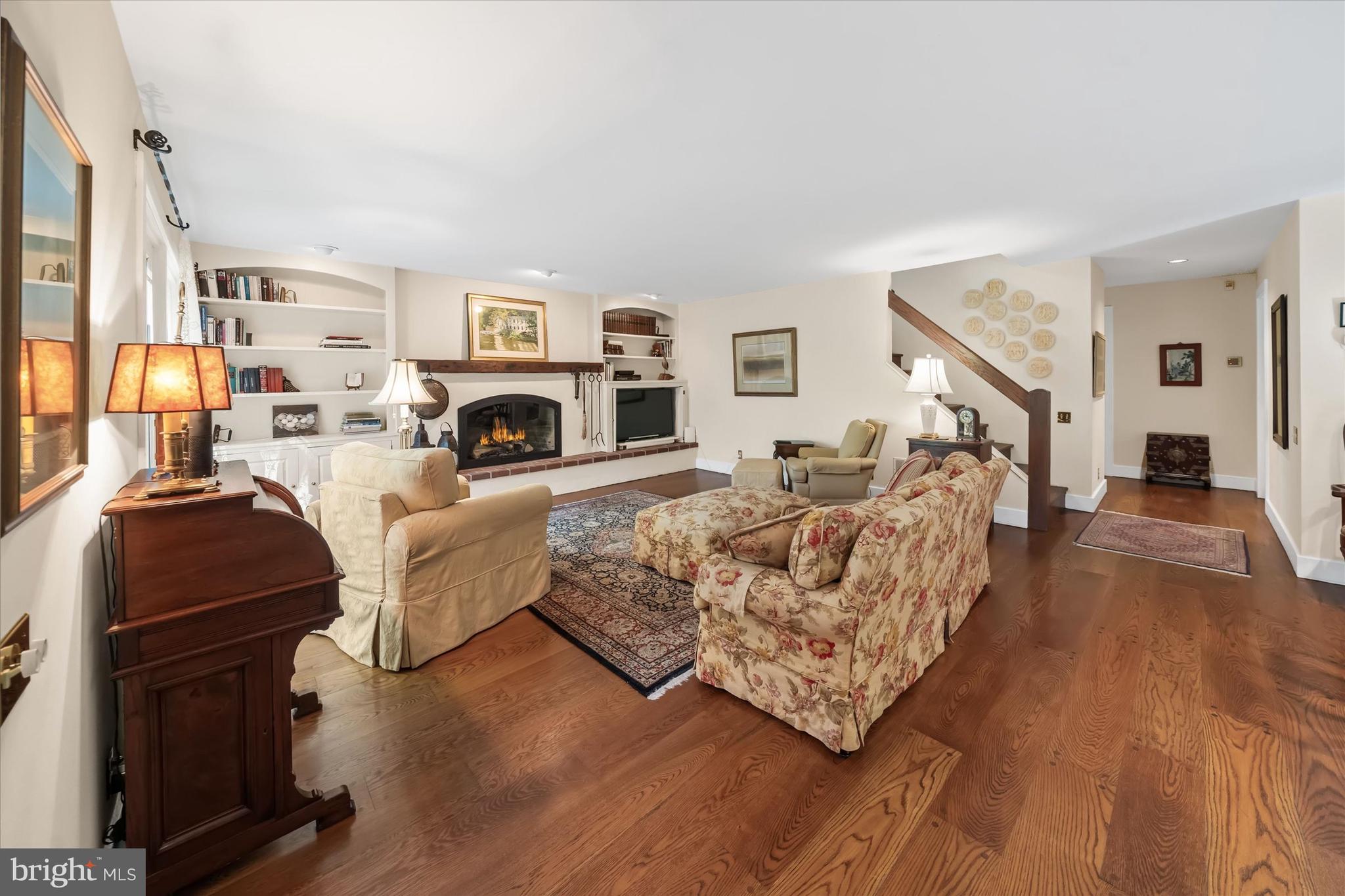 6 Carriage Road Greenville, DE 19807 - Photo 32 of 59 a living room with fireplace furniture and a wooden floor