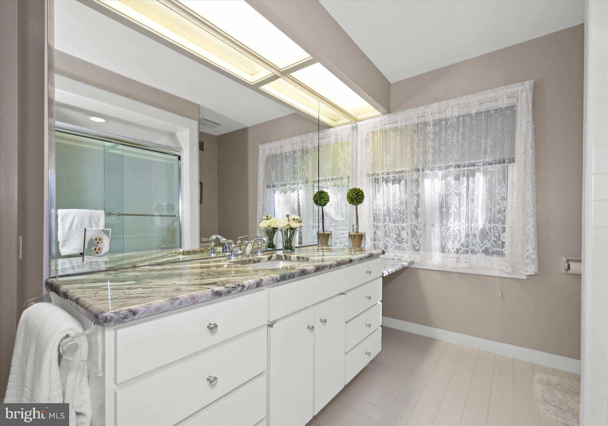 6 Carriage Road Greenville, DE 19807 - Photo 43 of 59 a bathroom with a granite countertop sink mirror and cabinets