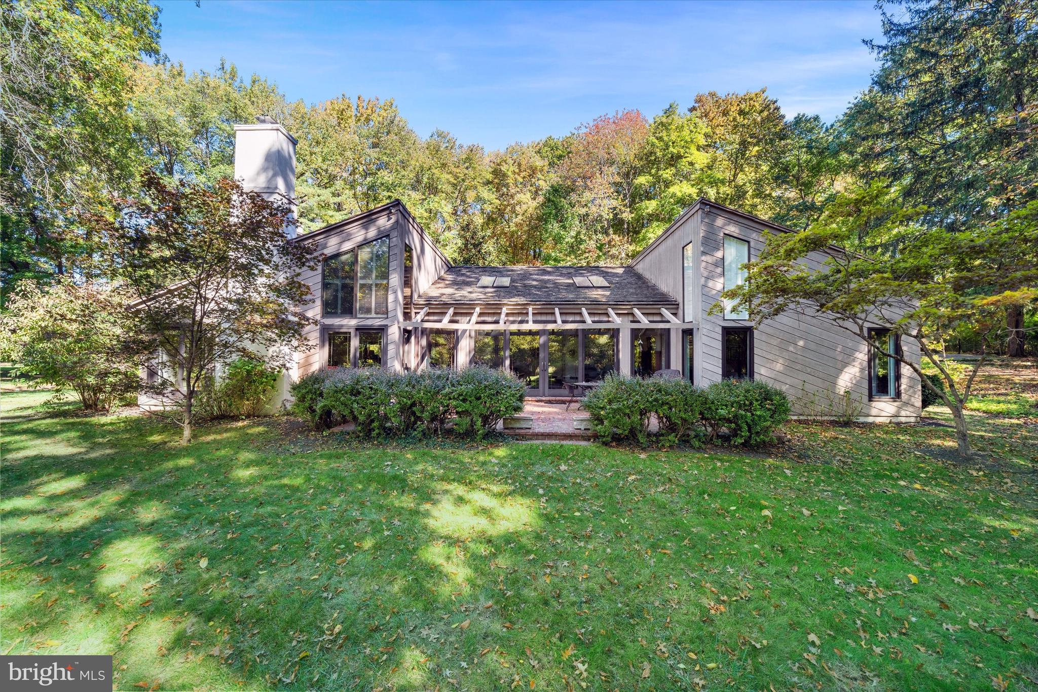 6 Carriage Road Greenville, DE 19807 - Photo 50 of 59 a front view of a house with a garden