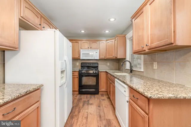 a kitchen with a sink a stove and a refrigerator