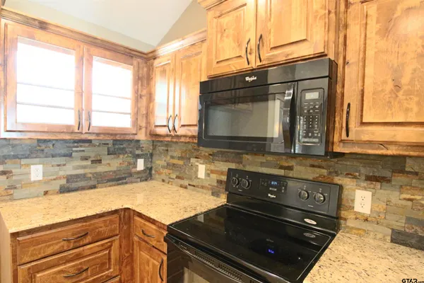 a kitchen with a stove and a sink