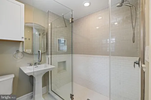 a bathroom with a toilet sink and shower