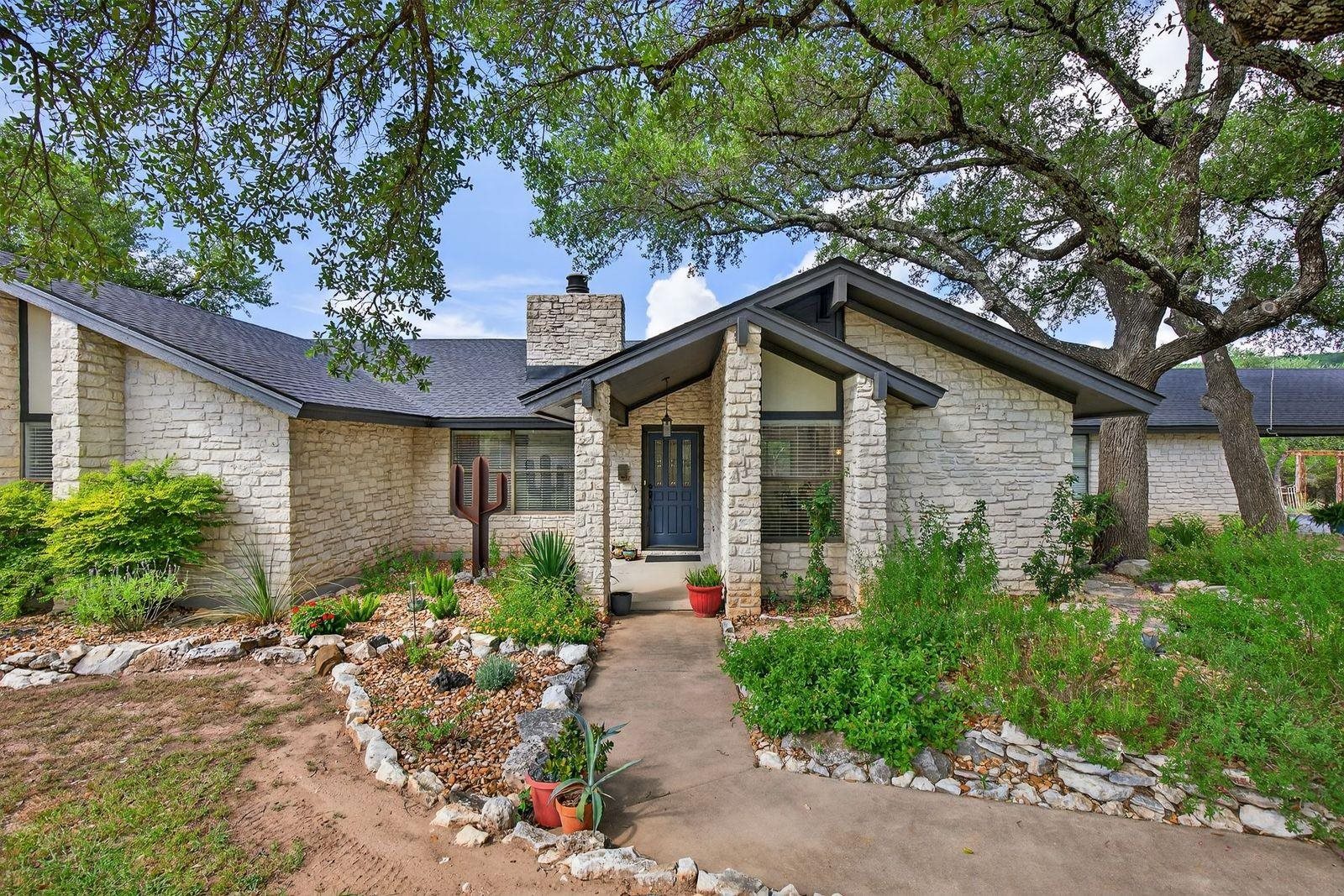 a front view of a house with garden