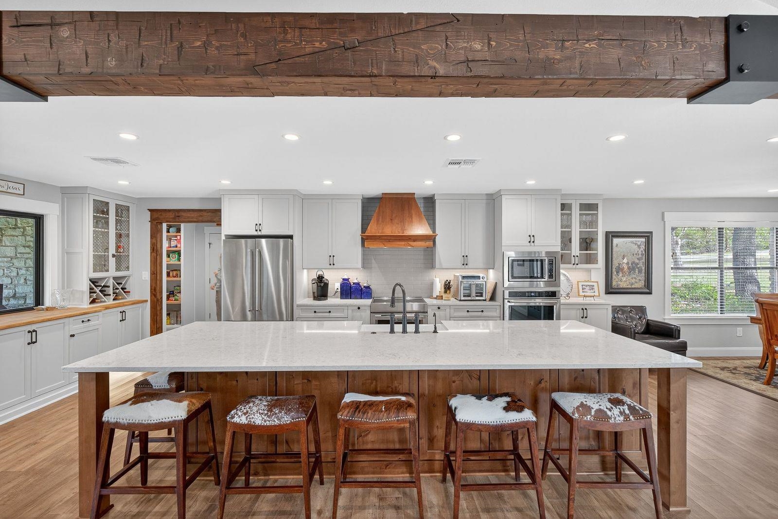 23644 Nameless Road Leander, TX 78641 - Photo 5 of 29 a dining hall with stainless steel appliances a table and chairs