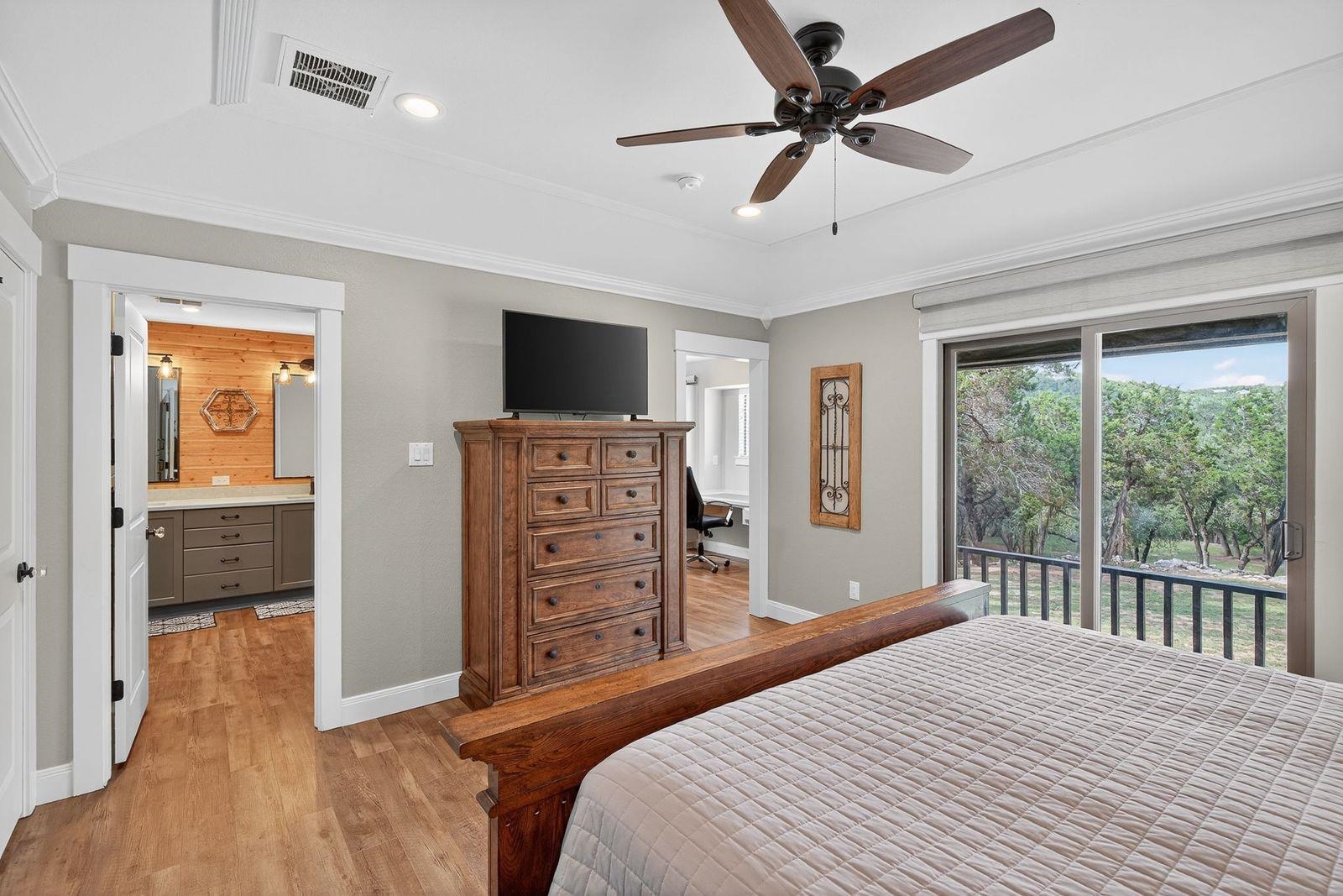 23644 Nameless Road Leander, TX 78641 - Photo 8 of 29 a bedroom with a bed and a flat tv screen