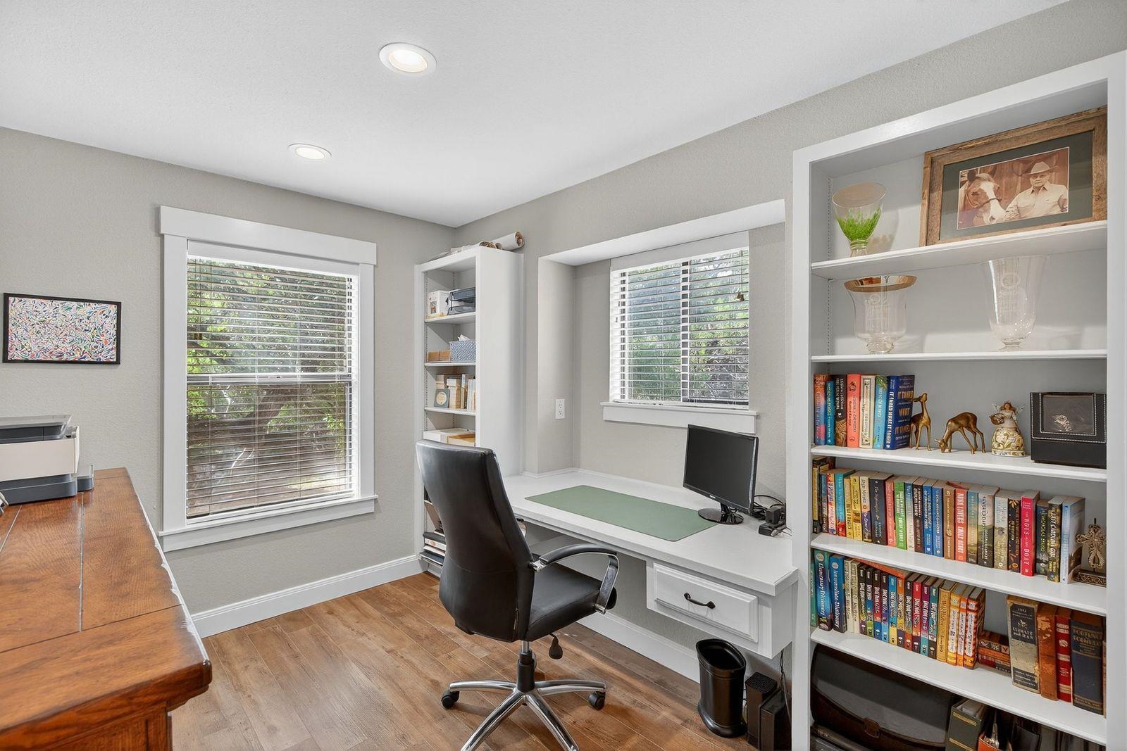 23644 Nameless Road Leander, TX 78641 - Photo 9 of 29 a view of a workspace with bookshelf and a window