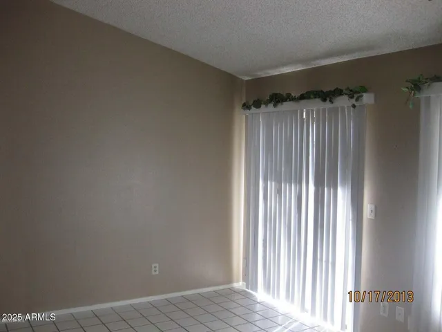 an empty room with wooden floor and a window