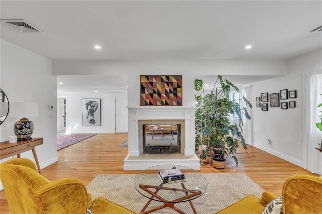 1057 Whitman Street Hanson, MA 02341 - Photo 12 of 40 a living room with furniture and a fireplace