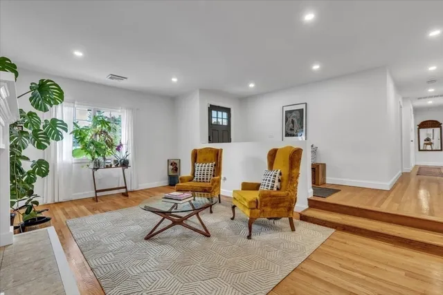 a living room with furniture rug and wooden floor