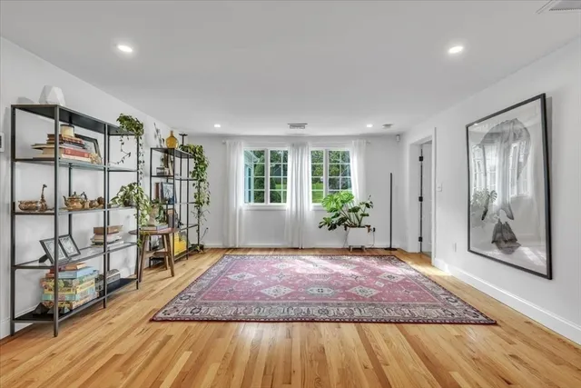 a view of a livingroom with wooden floor and door