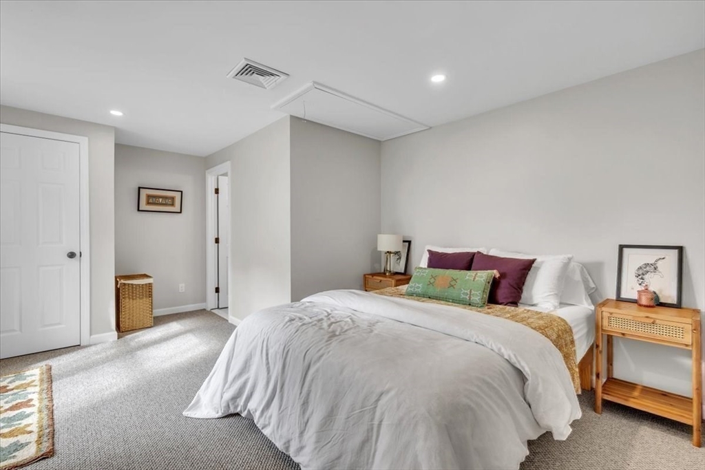 1057 Whitman Street Hanson, MA 02341 - Photo 24 of 40 a bedroom with a bed and a night stand