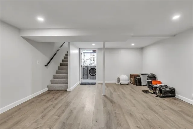 a view of a room with stairs and a wooden floor