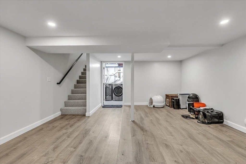 1057 Whitman Street Hanson, MA 02341 - Photo 29 of 40 a view of a room with stairs and a wooden floor