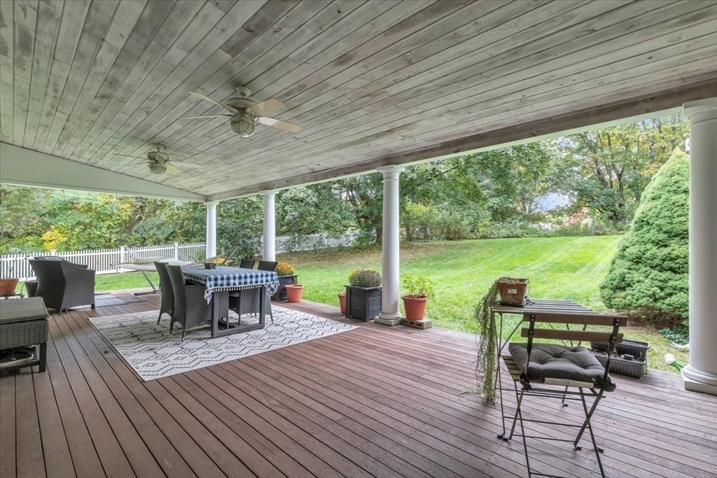 1057 Whitman Street Hanson, MA 02341 - Photo 30 of 40 a view of a patio with table and chairs potted plants with wooden floor and floor to ceiling window