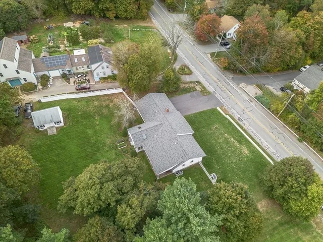 an aerial view of a house with outdoor space