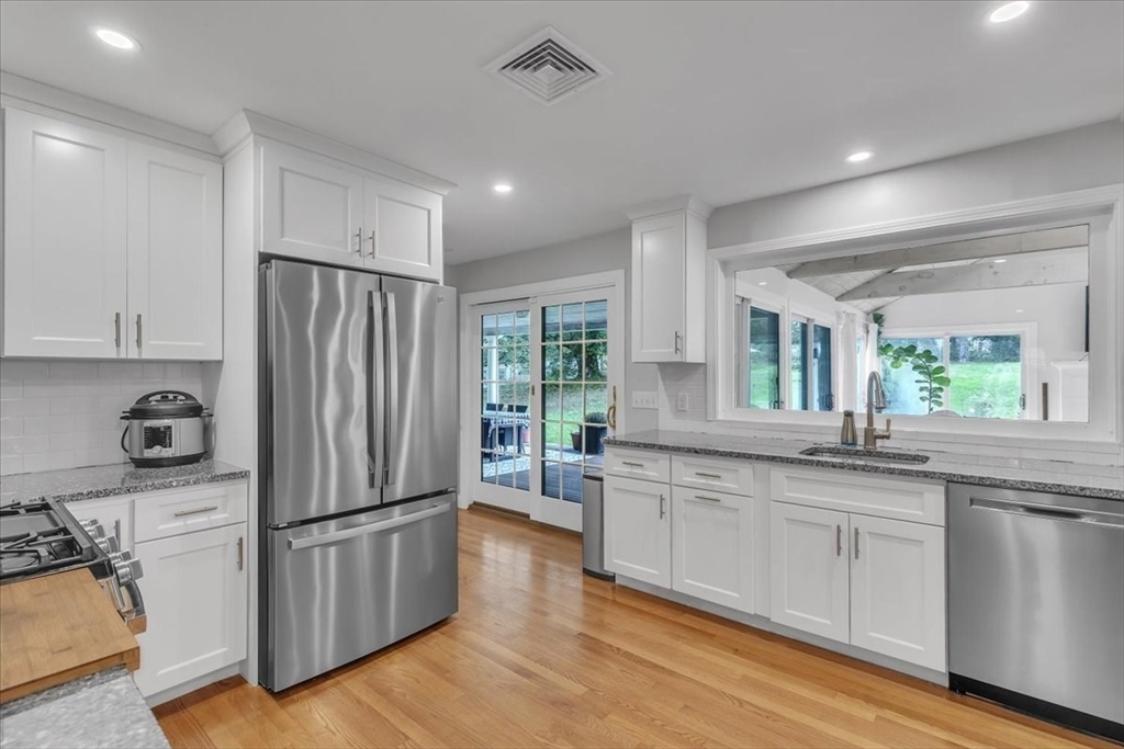 1057 Whitman Street Hanson, MA 02341 - Photo 5 of 40 a kitchen with stainless steel appliances a refrigerator sink and cabinets