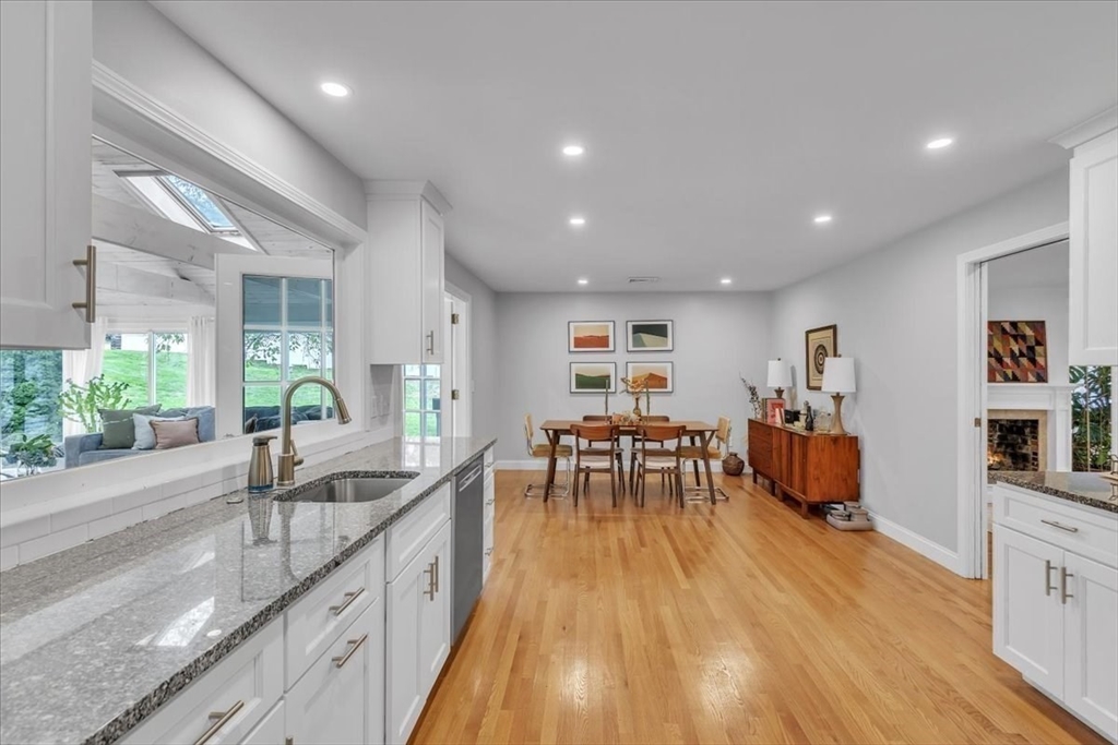 1057 Whitman Street Hanson, MA 02341 - Photo 9 of 40 a open kitchen with sink cabinets and wooden floor