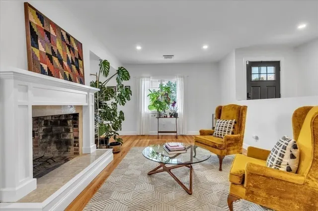 a living room with furniture and a fireplace
