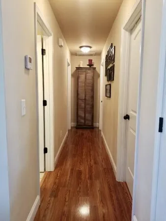 a view of hallway with wooden floor