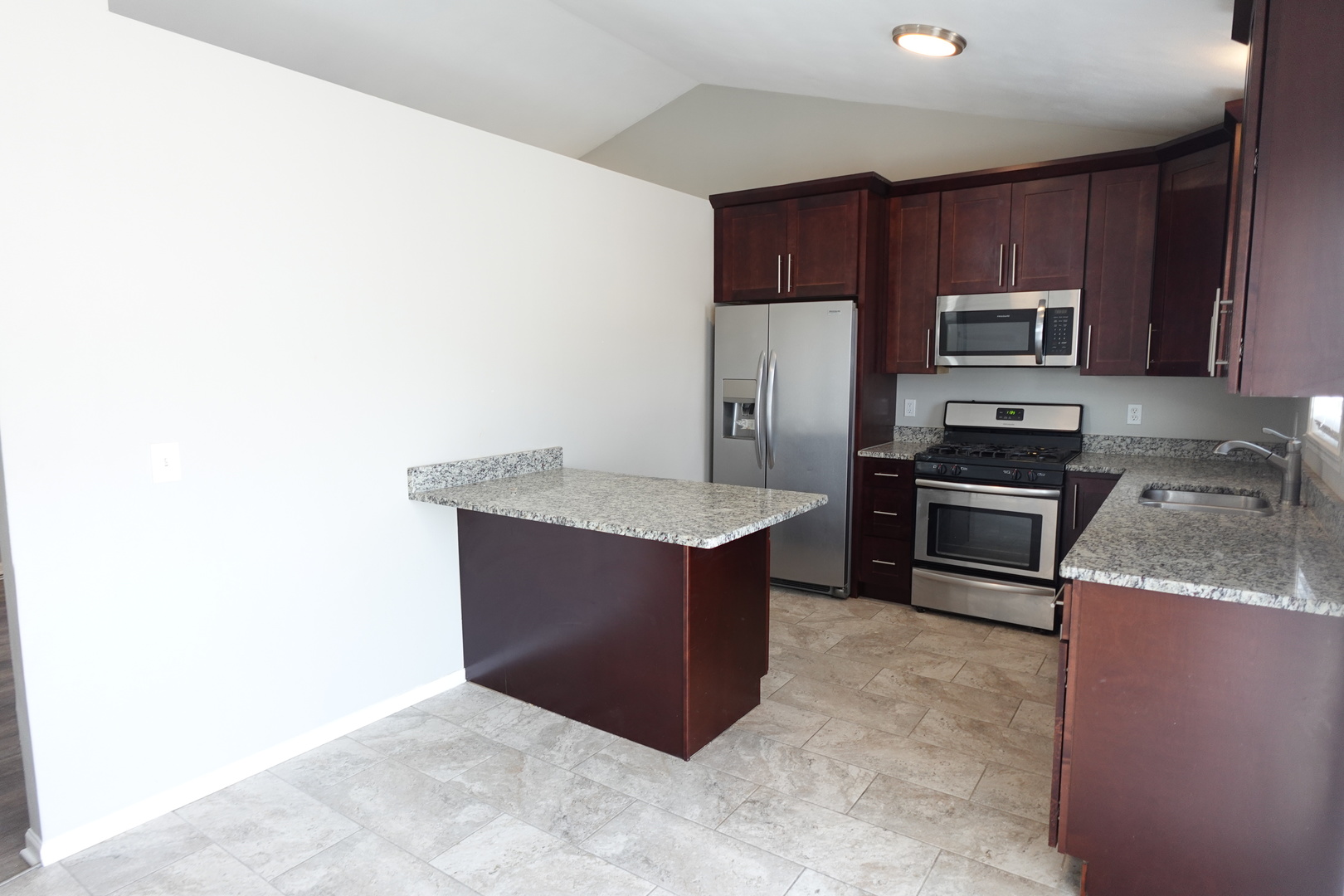 2140 Maxine Lane Rockford, IL 61102 - Photo 7 of 23 a kitchen with stainless steel appliances granite countertop a stove a microwave and a refrigerator