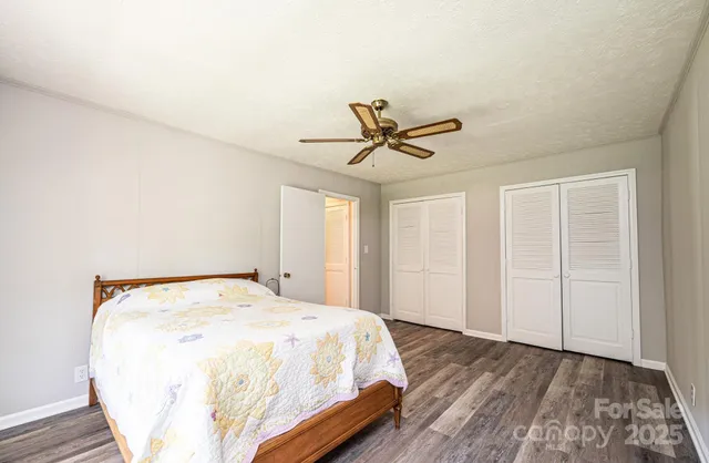 a spacious bedroom with a bed and a window