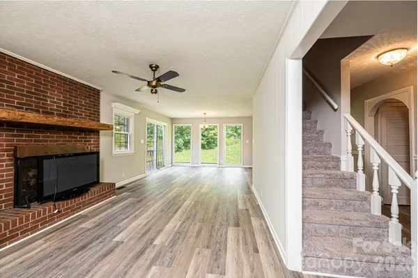 a bed sitting in a spacious bedroom next to a window