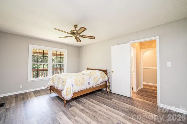 a spacious bedroom with a bed and a window