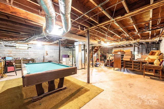 an aerial view of a house with garden space and a bench