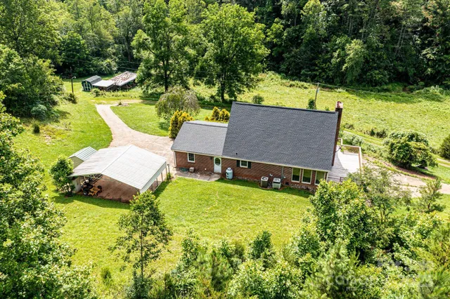 an aerial view of a house with swimming pool garden and patio