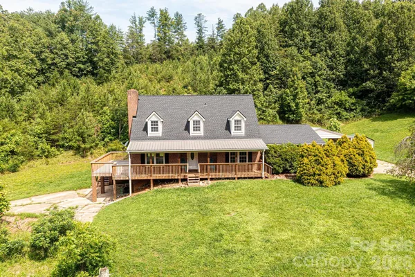 a view of a house with garden and sitting area