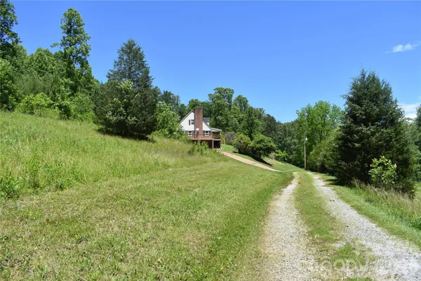 a view of a livingroom with wooden floor and a fireplace