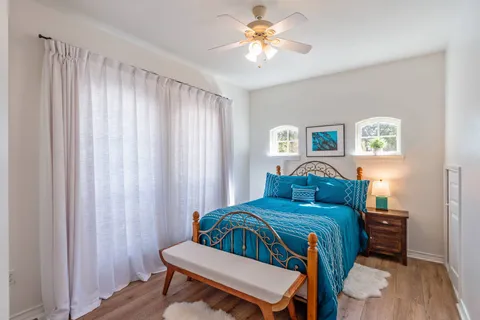 a bedroom with a bed and a chandelier